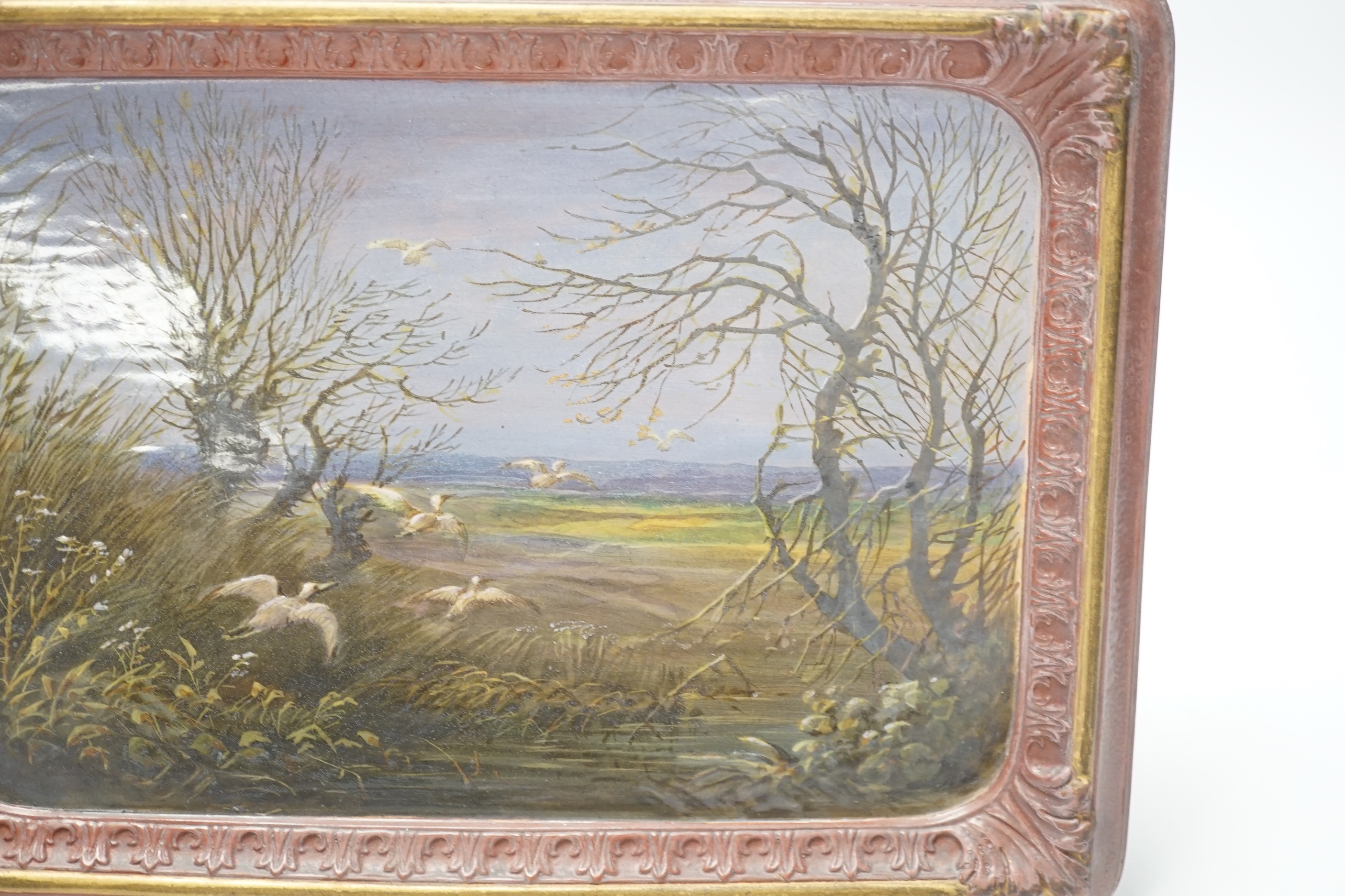 A late 19th century French painted faience plaque of storks in a landscape, 18 x 25cm